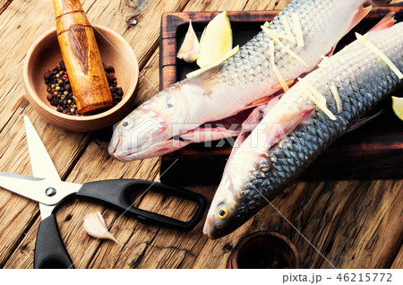 Whole raw spiced fish 46215772