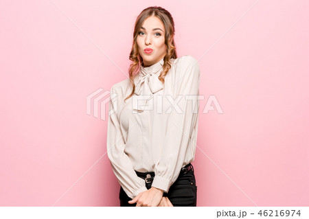 Let me think. Doubtful pensive woman with thoughtful expression making choice against pink 46216974