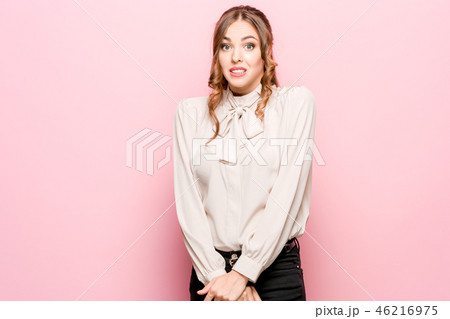 Let me think. Doubtful pensive woman with thoughtful expression making choice against pink 46216975