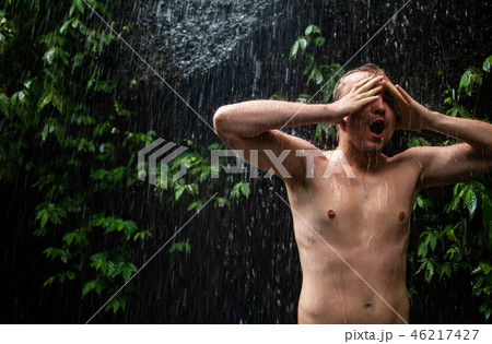 Closeup portrait of a muscular man posing in a tropical forest.Free place for your logo or text 46217427