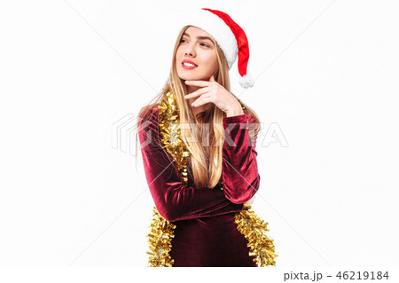 Beautiful girl in the hat of Santa thoughtfully Beautiful girl in the hat of Santa thoughtfully 46219184