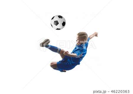 Young boy with soccer ball doing flying kick 46220363