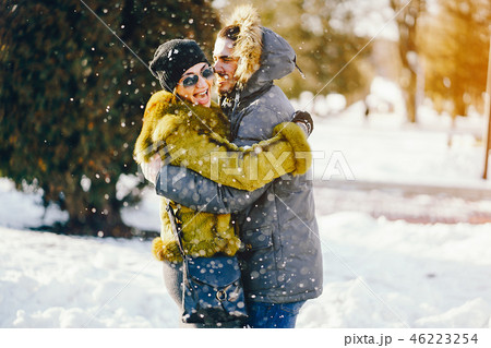 happy couple walking through the park on a sunny winter day happy couple walking through the park on a sunny winter day 46223254