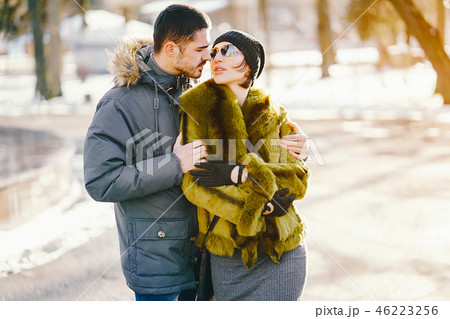happy couple walking through the park on a sunny winter day happy couple walking through the park on a sunny winter day 46223256