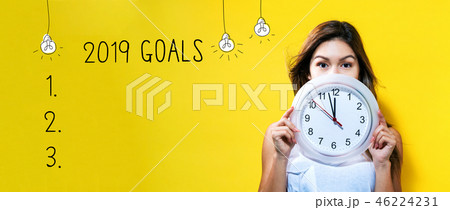 2019 goals with young woman holding a clock 46224231