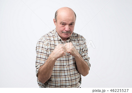 Man standing in boxer pose with raised fists 46225527