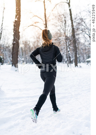Female athlete jogging in park in winter 46225949