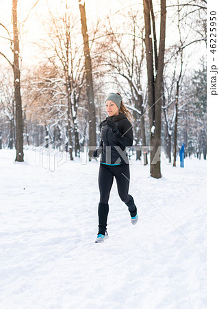 Female athlete jogging in park in winter 46225950