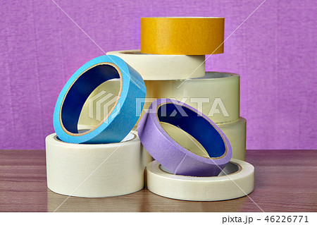 Pile of sticky tape lies on table, on purple  46226771