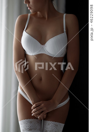 Fitness woman with a beautiful body. Girl in white underwear. 46229098