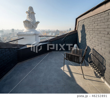Cozy small terrace with brick walls on sunny cityscape backgroun 46232891
