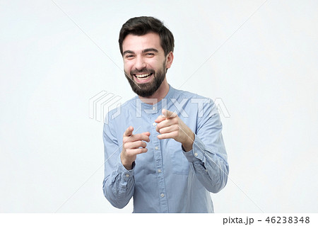 Portrait of a young man pointing his finger at you 46238348