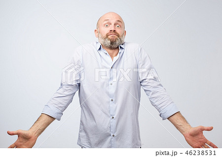 Confused mature bearded man shrugging shoulders 46238531