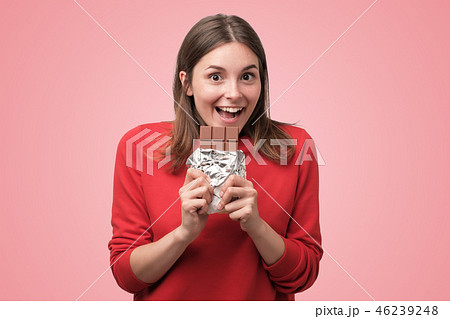 beautiful caucasian girl eating chocolateの写真素材 [46239248] - PIXTA