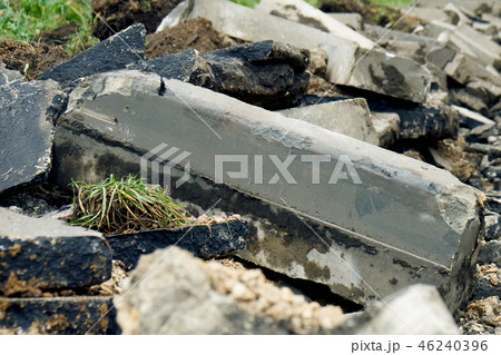 Broken freshly dug up old curbstones with pieces of an asphalt and earth lying on the road in Moscow 46240396