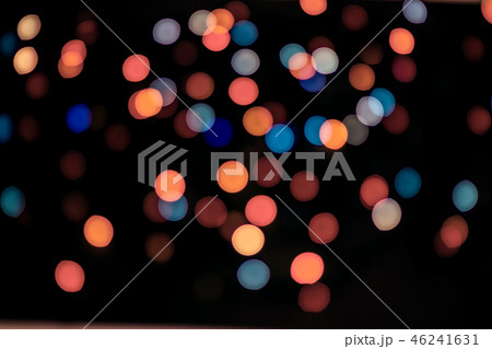 Abstract living coral and blue bokeh texture on black background. 46241631