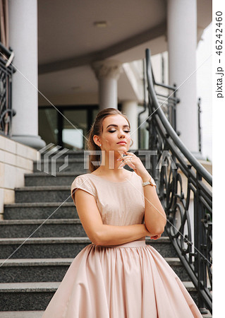 Elegant lady satnd on stairs in front of restaurant Elegant lady satnd on stairs in front of restaurant 46242460