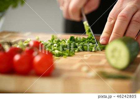 Cook holds knife in hand and cuts on Cook holds knife in hand and cuts on 46242805