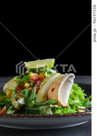 Tostada with beef, pepper, tomato, corn, mustard 46247336