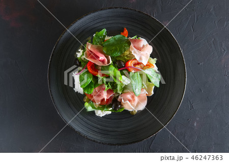 Fresh salad with jamon, mozzarella and tomato Fresh salad with jamon, mozzarella and tomato 46247363
