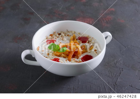 Oatmeal with dried apricots, nuts, strawberry jam 46247428