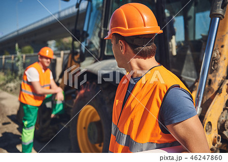 Foremans in orange vests are working outdoor Foremans in orange vests are working outdoor 46247860