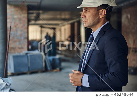 Thoughtful architect is standing on construction site Thoughtful architect is standing on construction site 46248044