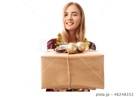Happy young woman in Santa Claus hat, in hands Happy young woman in Santa Claus hat, in hands 46248352