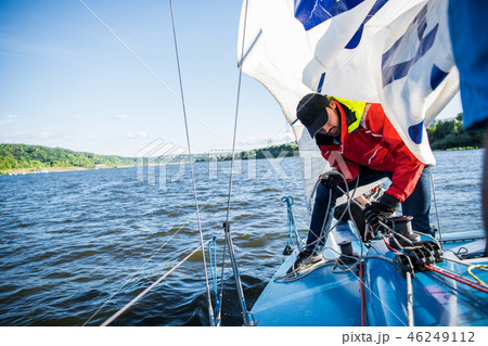 Yacht sailor pulling rope. Man working on sailboat. Yacht sailor pulling rope. Man working on sailboat. 46249112