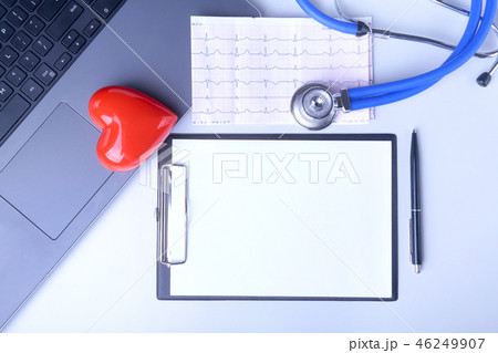 Workplace of doctor with laptop, stethoscope, red heart and RX prescription on white table. top view 46249907