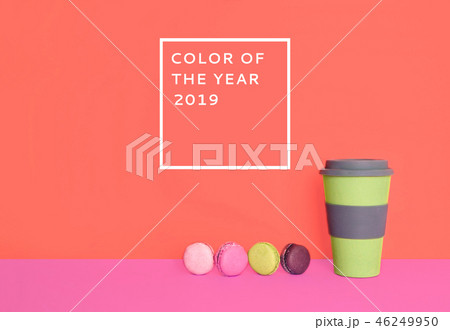 Cup of coffee to go with macarons on trendy background. Cup of coffee to go with macarons on trendy background. 46249950