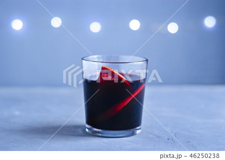 Glass of red beverage with citrus slices Glass of red beverage with citrus slices 46250238