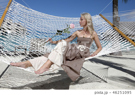 beautiful woman in a long sundress in a hammock on 46251095