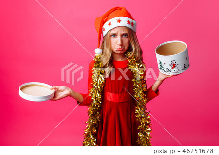 Frustrated teenage girl in Santa hat and tinsel  46251678
