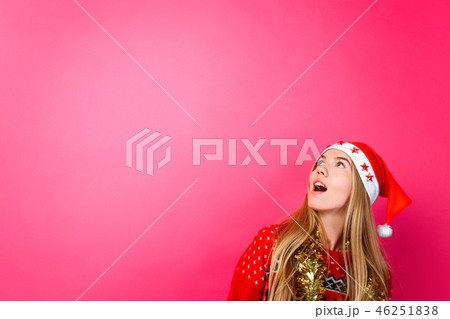 A beautiful surprised girl in Santa's hat A beautiful surprised girl in Santa's hat 46251838