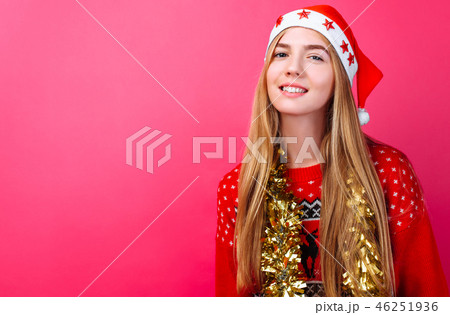 girl in a red sweater and Santa hat, with tinsel  46251936