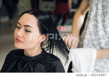 Attractive woman smiling while having a consultation with her hair stylist. 46253007