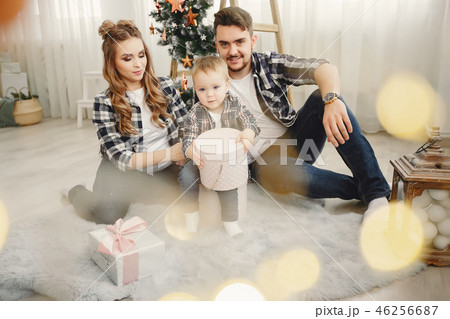 Cute family sitting near Christmas tree 46256687
