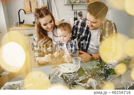 Cute family sitting in the kitchen Cute family sitting in the kitchen 46256716