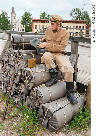 Retro picture with soldier sitting on the bundles Retro picture with soldier sitting on the bundles 46256803