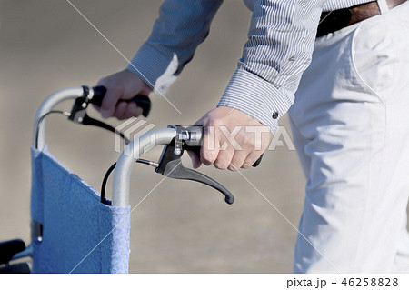 車いすを押す男性の手元のアップ。介護、介助、福祉、老後、障害イメージ 46258828