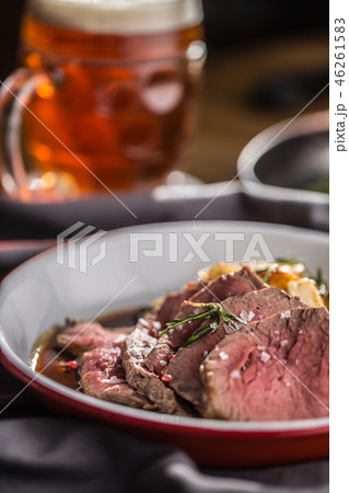 Sliced Beef tenderloin roasted steak with beer. 46261583