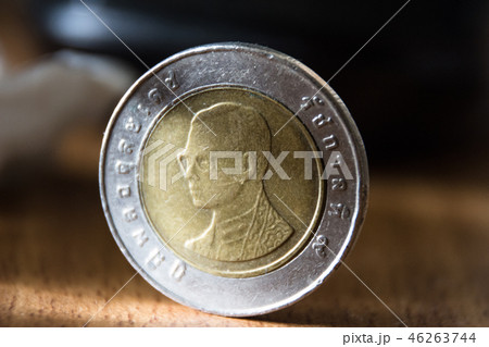 thai coin close-up view on wooden ground,ten bath thai coin close-up view on wooden ground,ten bath 46263744
