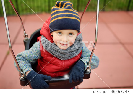 Cute little boy having fun on outdoor playground. Cute little boy having fun on outdoor playground. 46268243