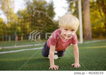 Little boy having fun playing a soccer/football 46268259