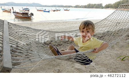 Happy boy in hammock on beach Happy boy in hammock on beach 46272112