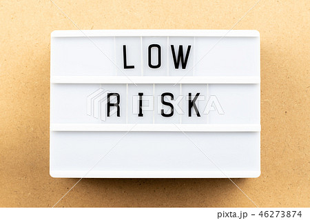 Light box with word low risk on wood background 46273874