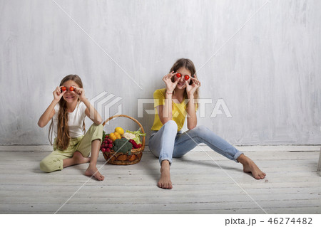 beautiful girl with a basket of fresh vegetables, radishes, broccoli, tomato pepper 46274482