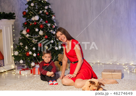 mother and little boy open Gifts Christmas tree new year 46274649