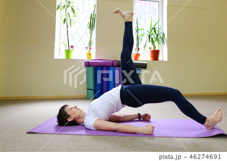 Beautiful girl doing stretching exercises and yoga asanas. Beautiful girl doing stretching exercises and yoga asanas. 46274691